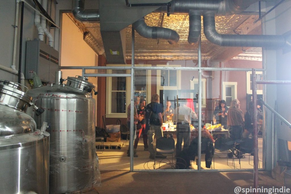 GRC attendees mingle in future brew pub space. Photo: J. Waits 