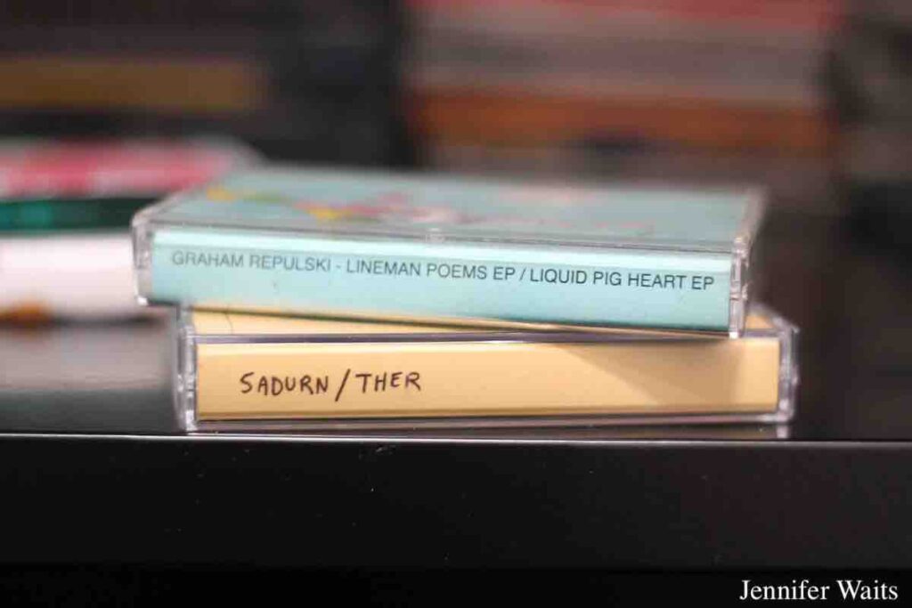 Cassette tapes at college radio station WPIR Pratt Radio in March, 2023. Cassette labels read: Graham Repulski - Lineman Poems EP/Liquid Pig Heart EP and Sadurn/Ther. Photo: J. Waits
